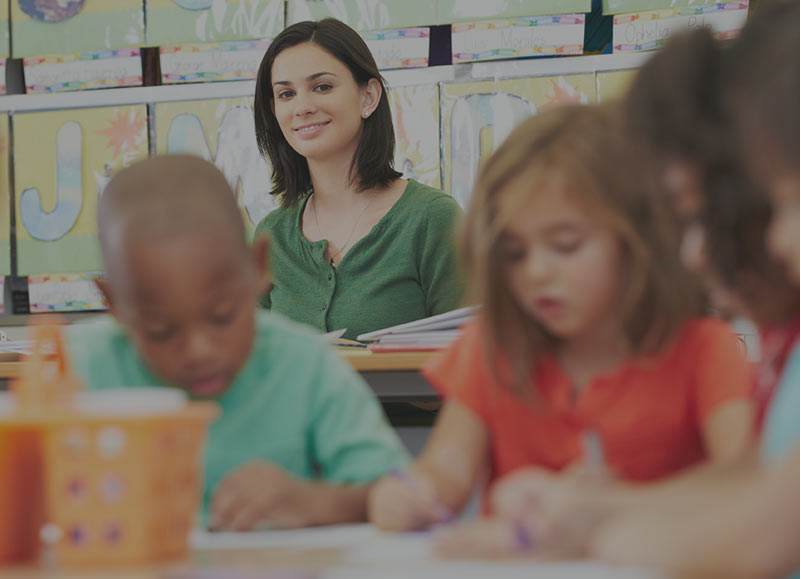 Teacher watching students take test