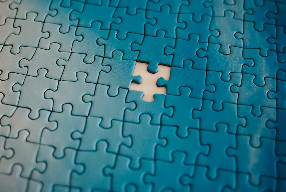 An image of a blue puzzle missing a single piece (SQL puzzles concept)