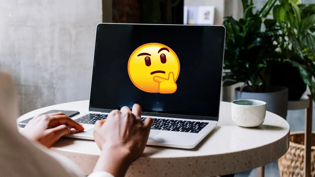 A person typing on a laptop with a thinking face emoji